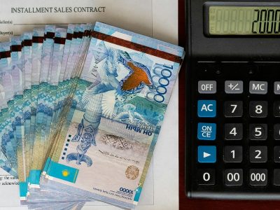 Tenge. Paper Kazakh money and calculator on the table close-up.